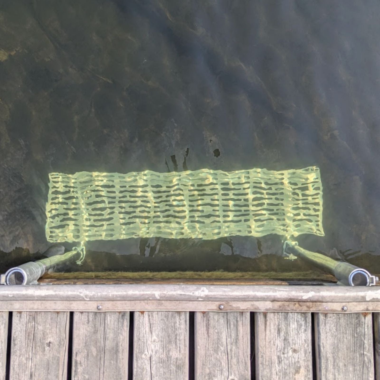 Overhead view of The Dock Ledge installed on a wooden dock in Haliburton, Ontario.